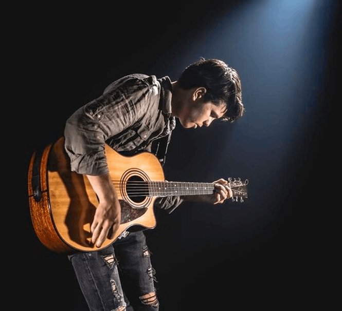 Musician playing acoustic guitar